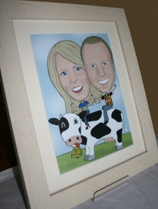 Framed A4 caricature of a couple on a cow's back